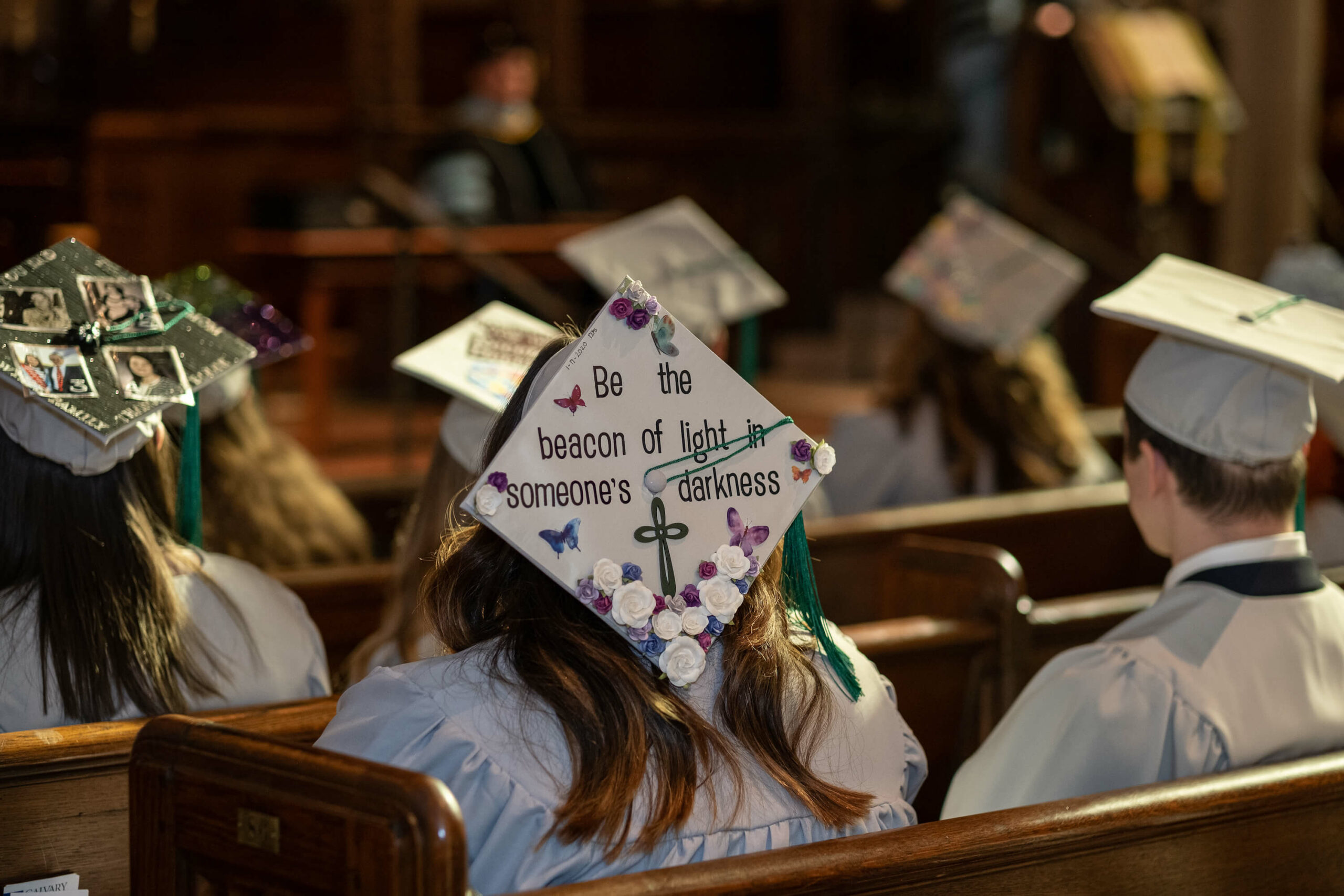 PIMS graduation image with be the beacon of light message on hat
